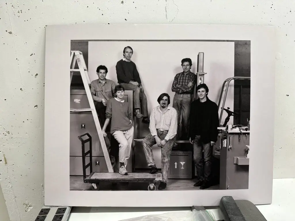 Photograph of a black and white photograph of a previous Preparation Department team including Michael Trevillion standing in the in the top left.
