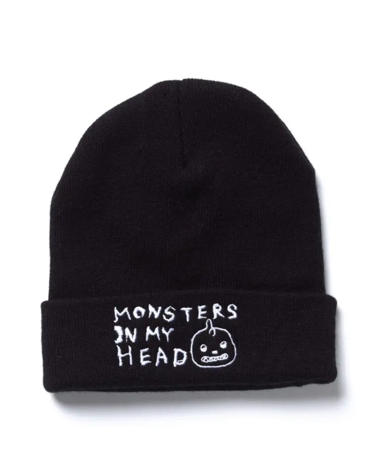 From of a black toque with English text in white "Monsters in My Head" and the Tanilla monster figure's head.