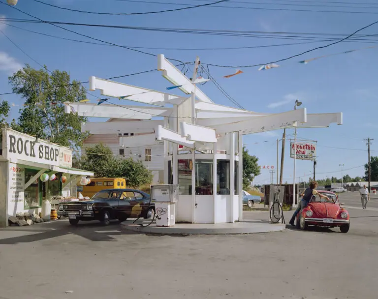 A colour photograph by Stephen Shore of a gas station.