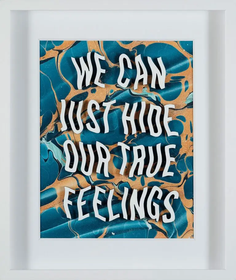 A photograph on an artwork in a white frame. The art is made up of text with blue and yellow hues in the background. The text reads "We can just hide our true feelings."
