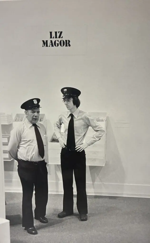 An archival photograph in black and white of two Security Guards talking