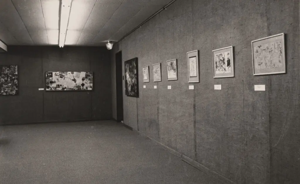 An archival photograph in black and white of an exhibition of artwork at a library in Terrace.