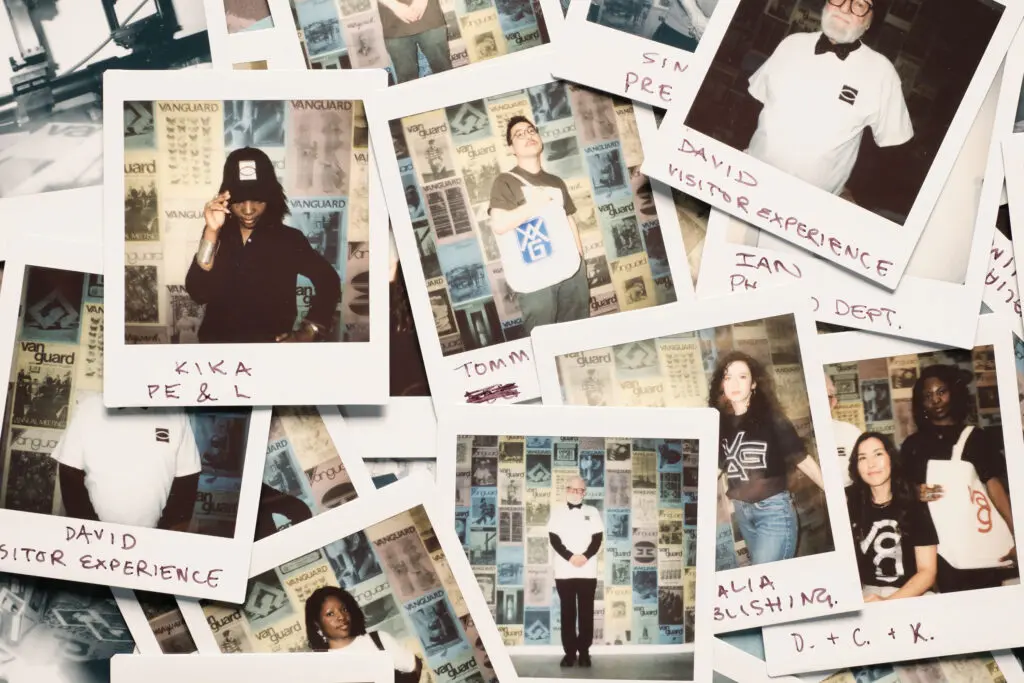 A photograph of an overlapping pile of colour polaroid images with handwritten text visible on the bottoms of each polaroid.