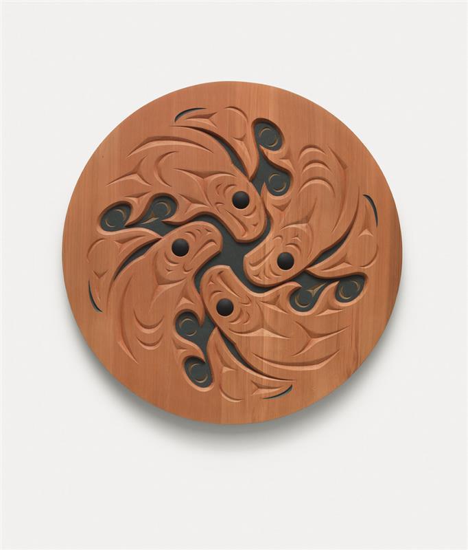 A sculpture by Susan Point of a wooden spindle whorl