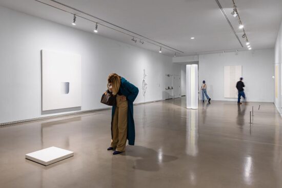 Gallery visitors looking at works in the exhibition Postcards from the Heart: Selections from the Brigitte and Henning Freybe Collection.