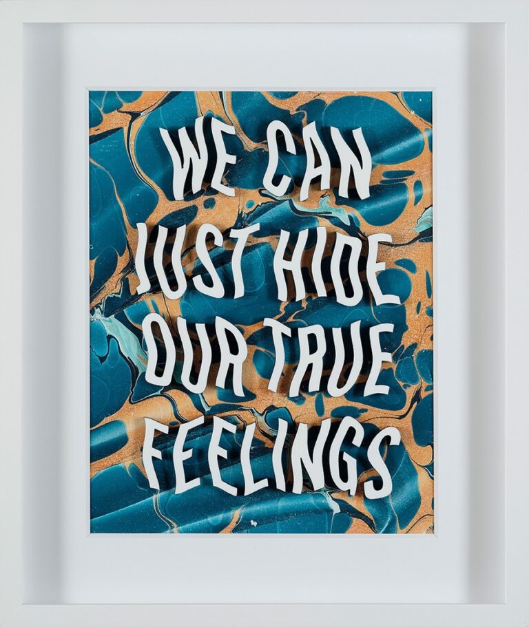 A photograph on an artwork in a white frame. The art is made up of text with blue and yellow hues in the background. The text reads "We can just hide our true feelings."